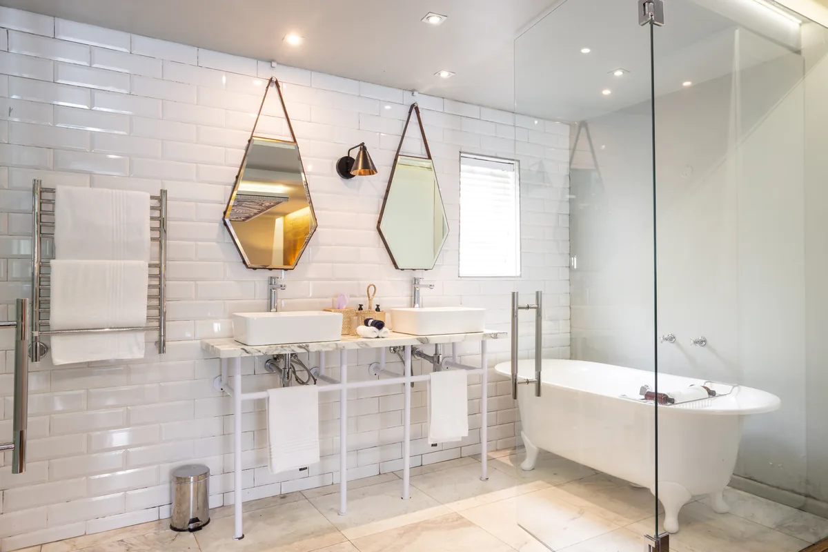 Pool Room bathroom with freestanding bath at Majeka House Boutique Hotel