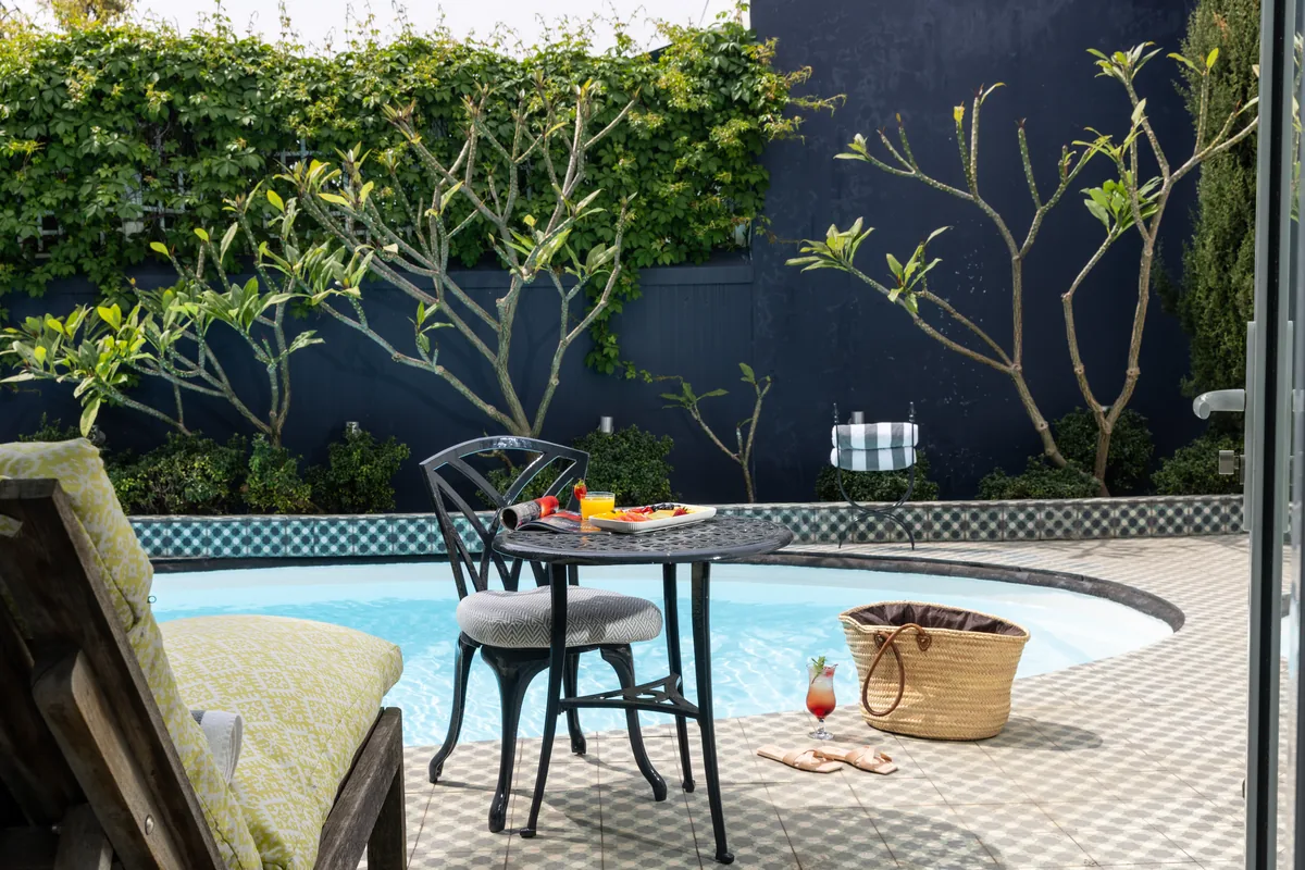 Patio beside the pool at Majeka House Boutique Hotel
