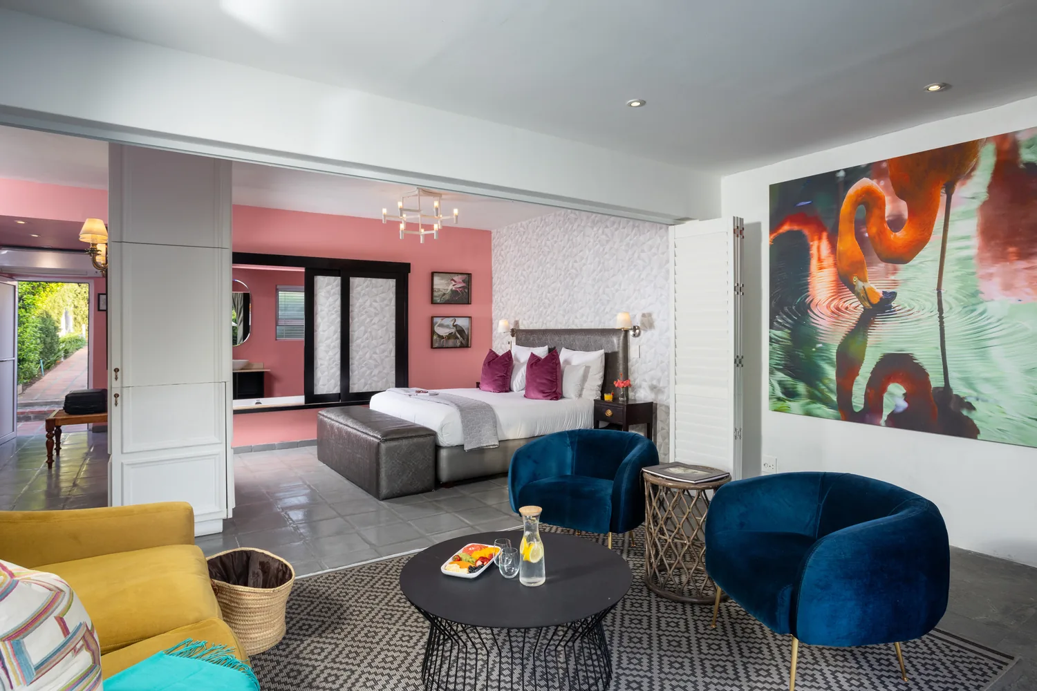 Pool Suite lounge and bedroom with flamingo artwork at Majeka House Boutique Hotel