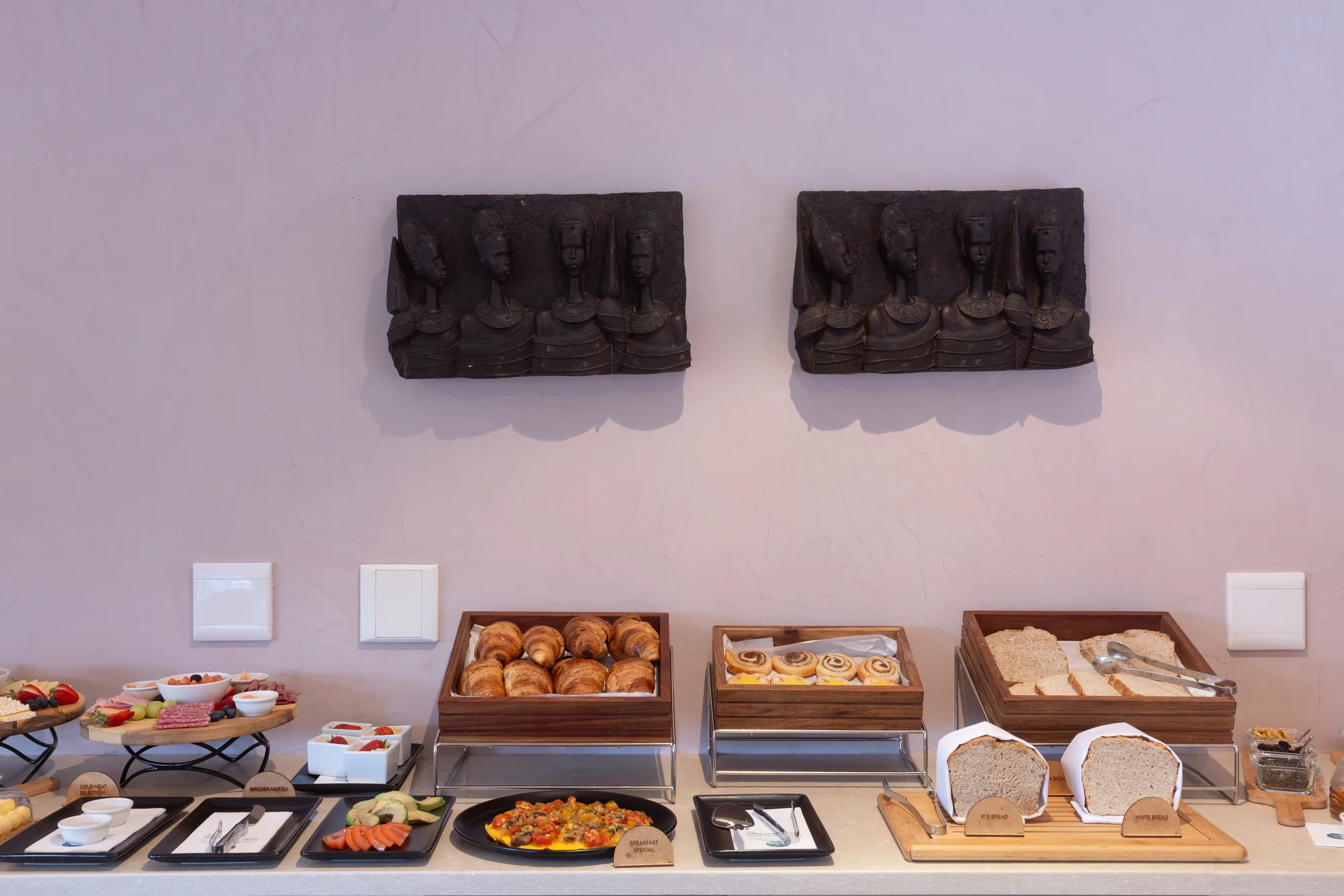 Breakfast buffet with croissants, pastries, breads and cold meats at Plumwood Boutique Hotel