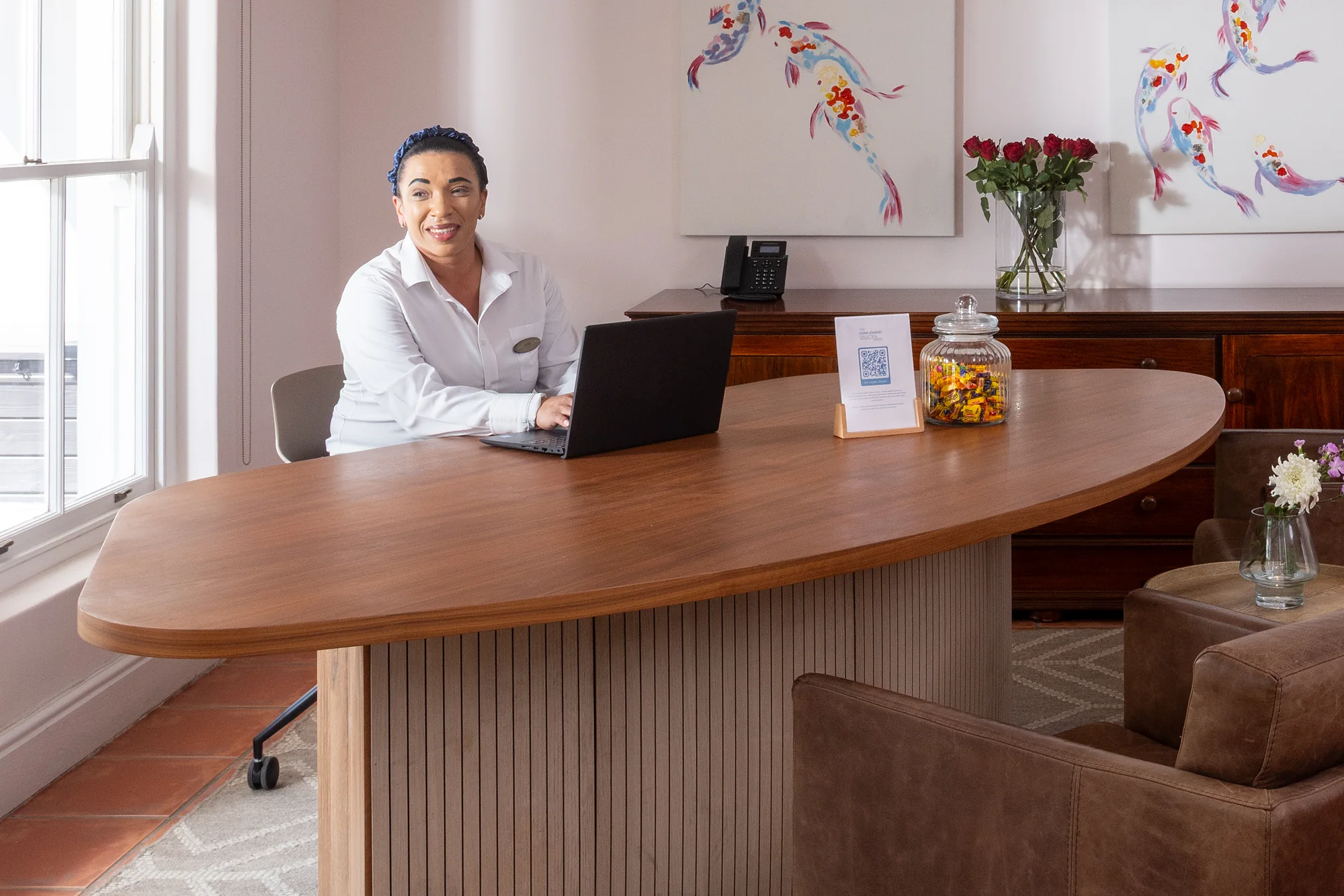 Receptionist at the reception desk at Plumwood Boutique Hotel